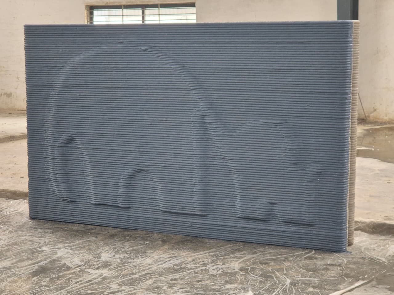 A printed panel carrying an arch motif formed by the deposition path.
