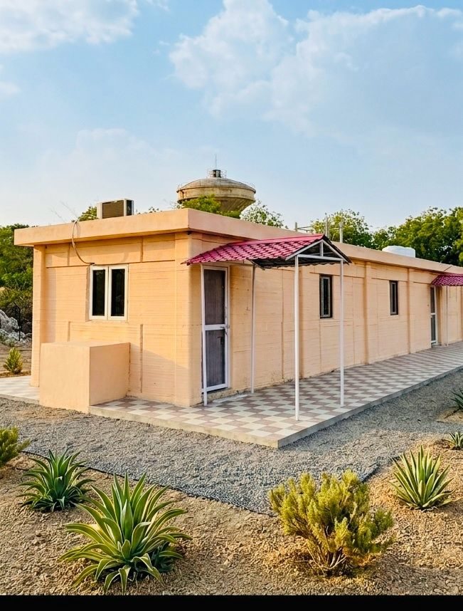 A 3D printed dwelling unit in its landscaped setting.